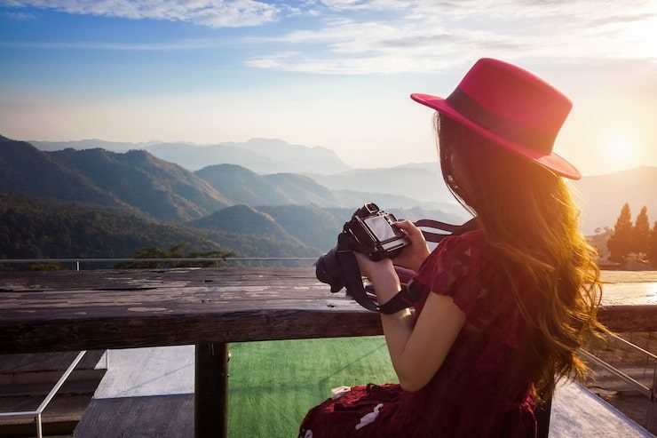 Photographer capturing Aranzazu sanctuary during golden hour using DSLR camera