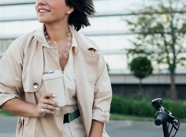 Professional candid lifestyle photography for business branding featuring a woman with a coffee cup in an urban setting.